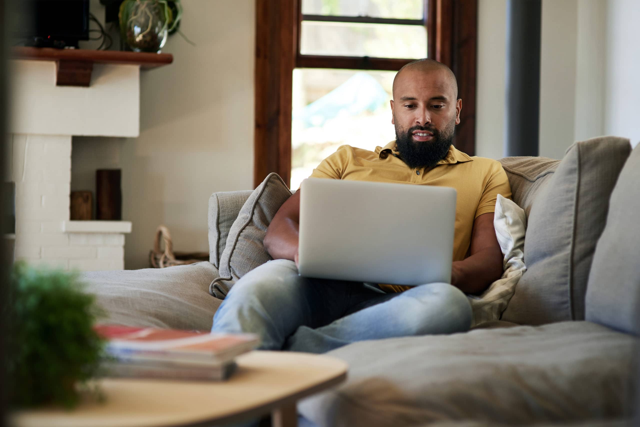 man on laptop researching vehicle loans