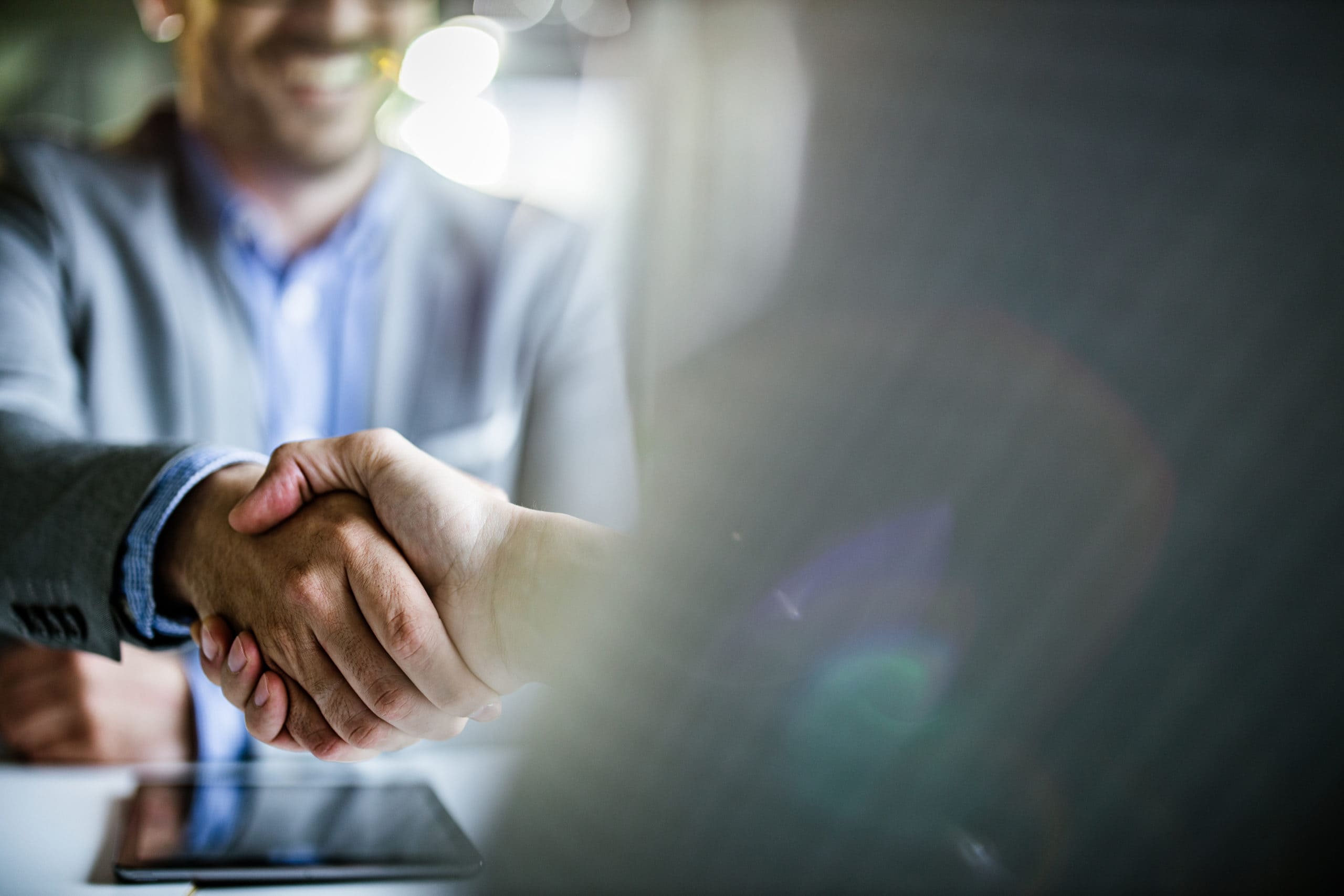 two men shake hands after financing vehicle